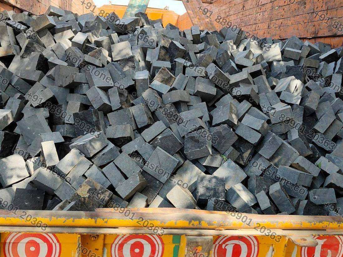 Black basalt cobbles laid wet in a regular grid