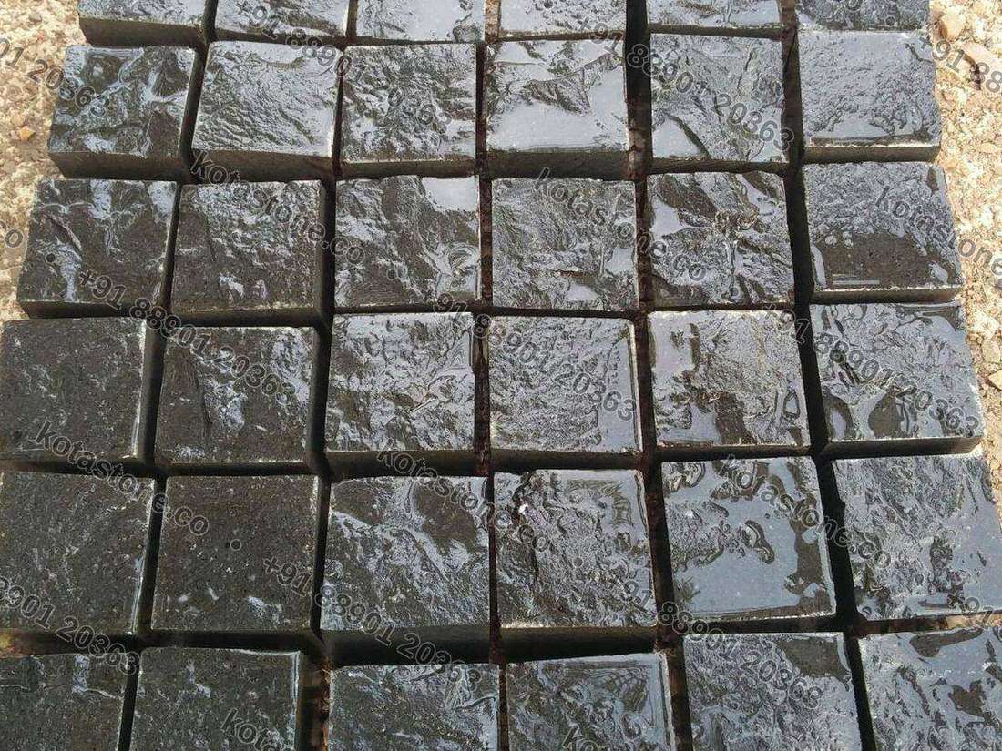 Black basalt cobbles, wet