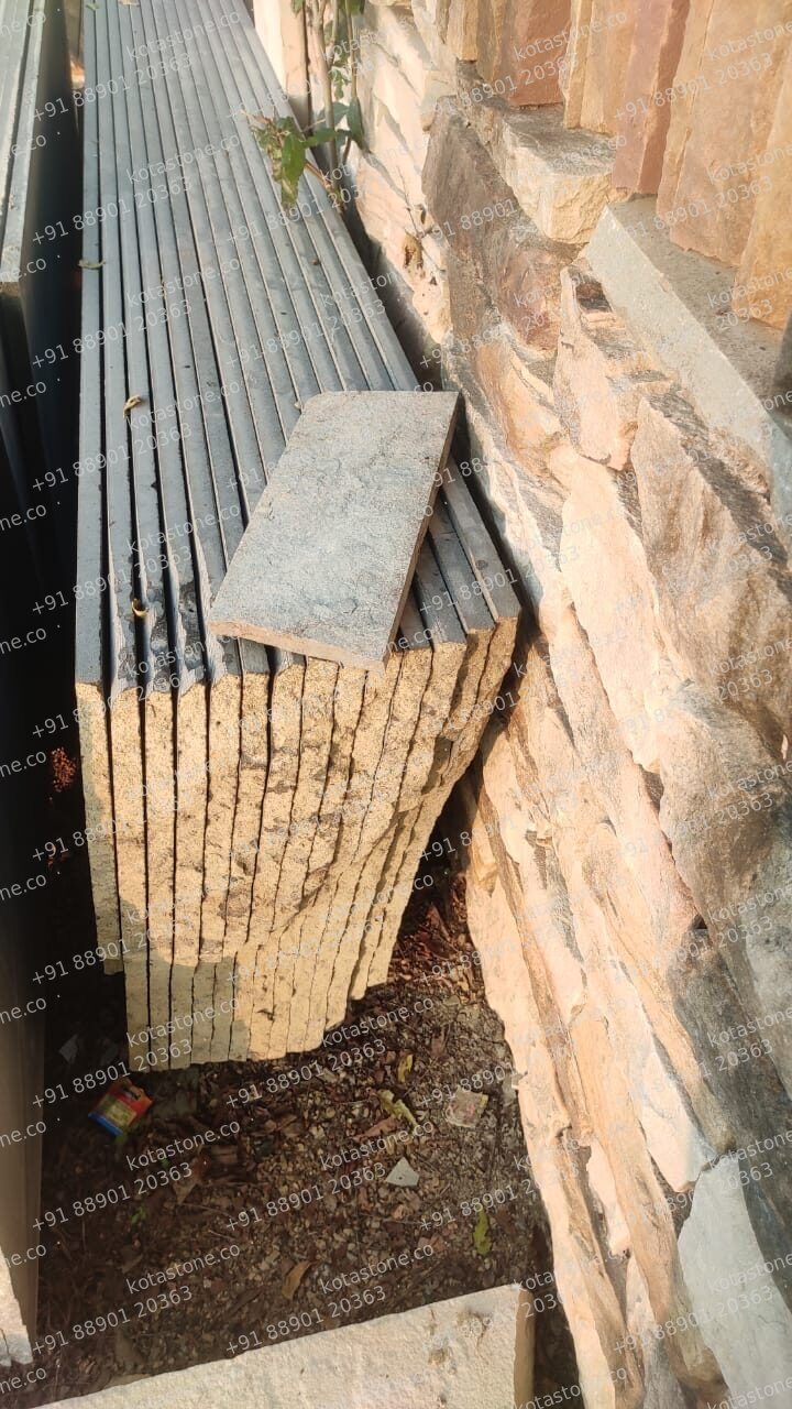 Grooved basalt stacked against sandstone