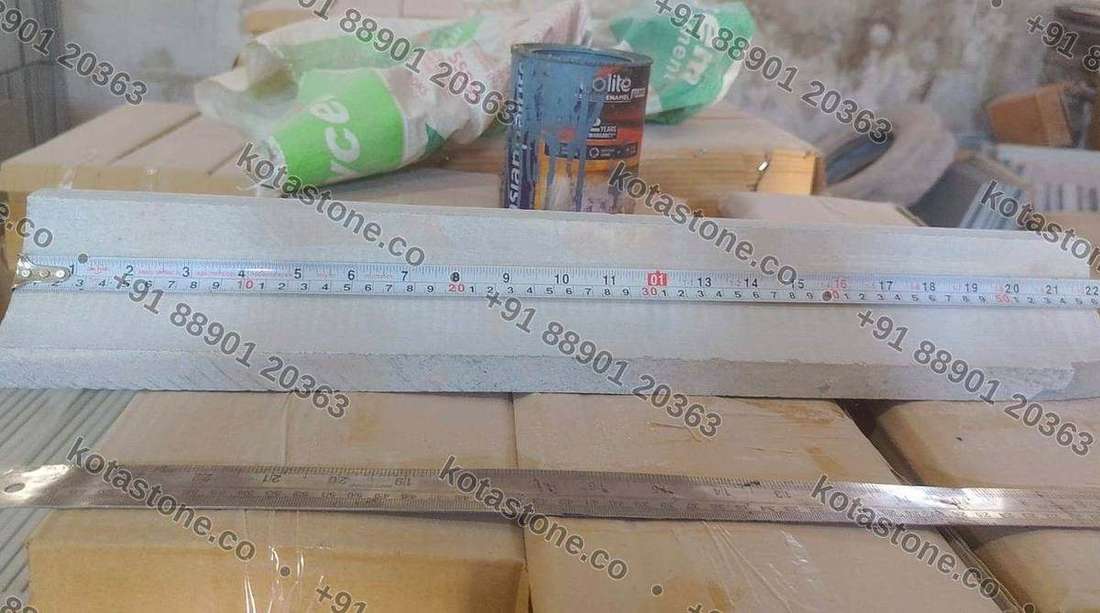 Steel rule laid along a run of coving to check length