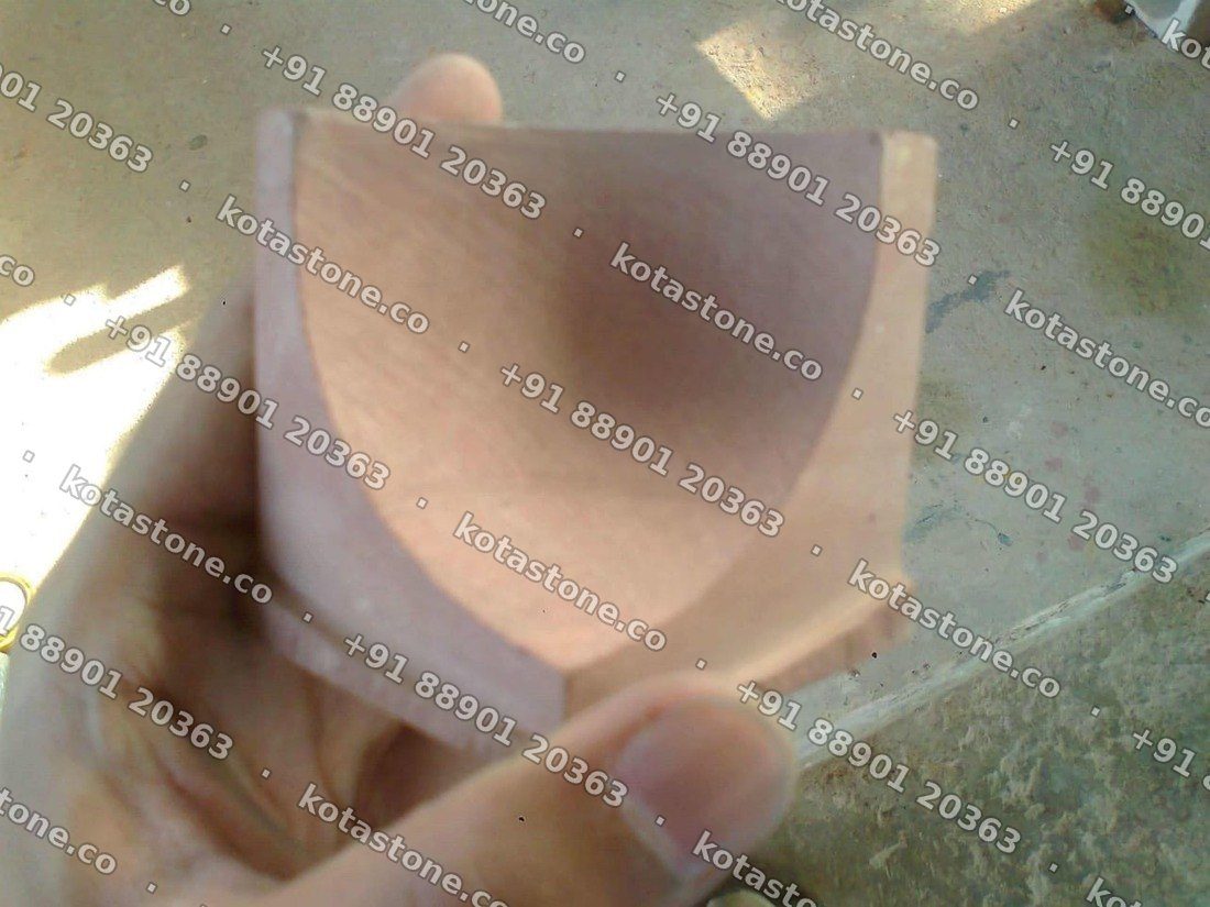 Internal corner piece for Mandana stone coving held in the hand