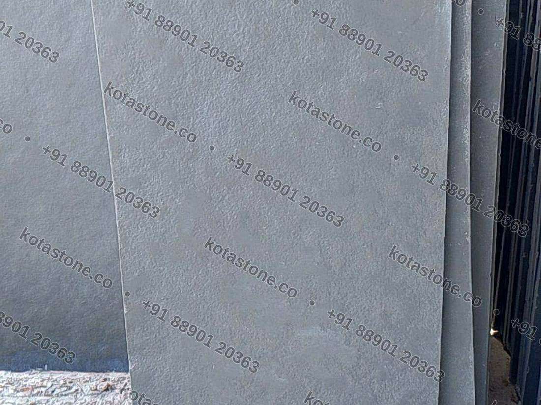 Calibrated green Kota slabs standing on edge in the yard